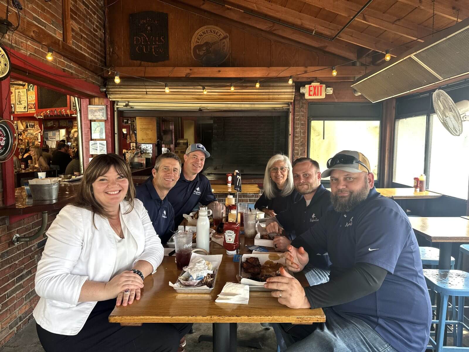 Magnolia inspectors and partners sharing a meal at a Nashville restaurant
